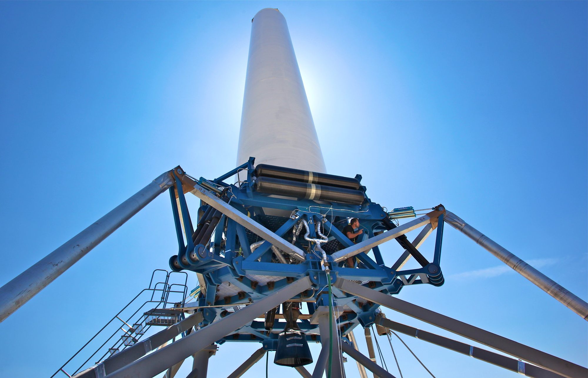 Grasshopper on its pad at McGregor, seen from below: the white tank above a blue steel frame and four legs.