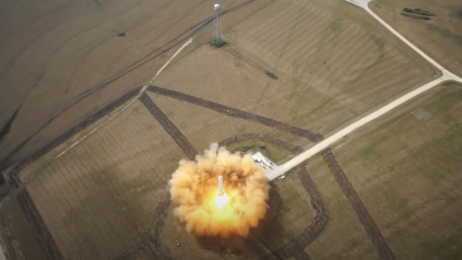Grasshopper over the pad at McGregor, seen from above by the camera drone.